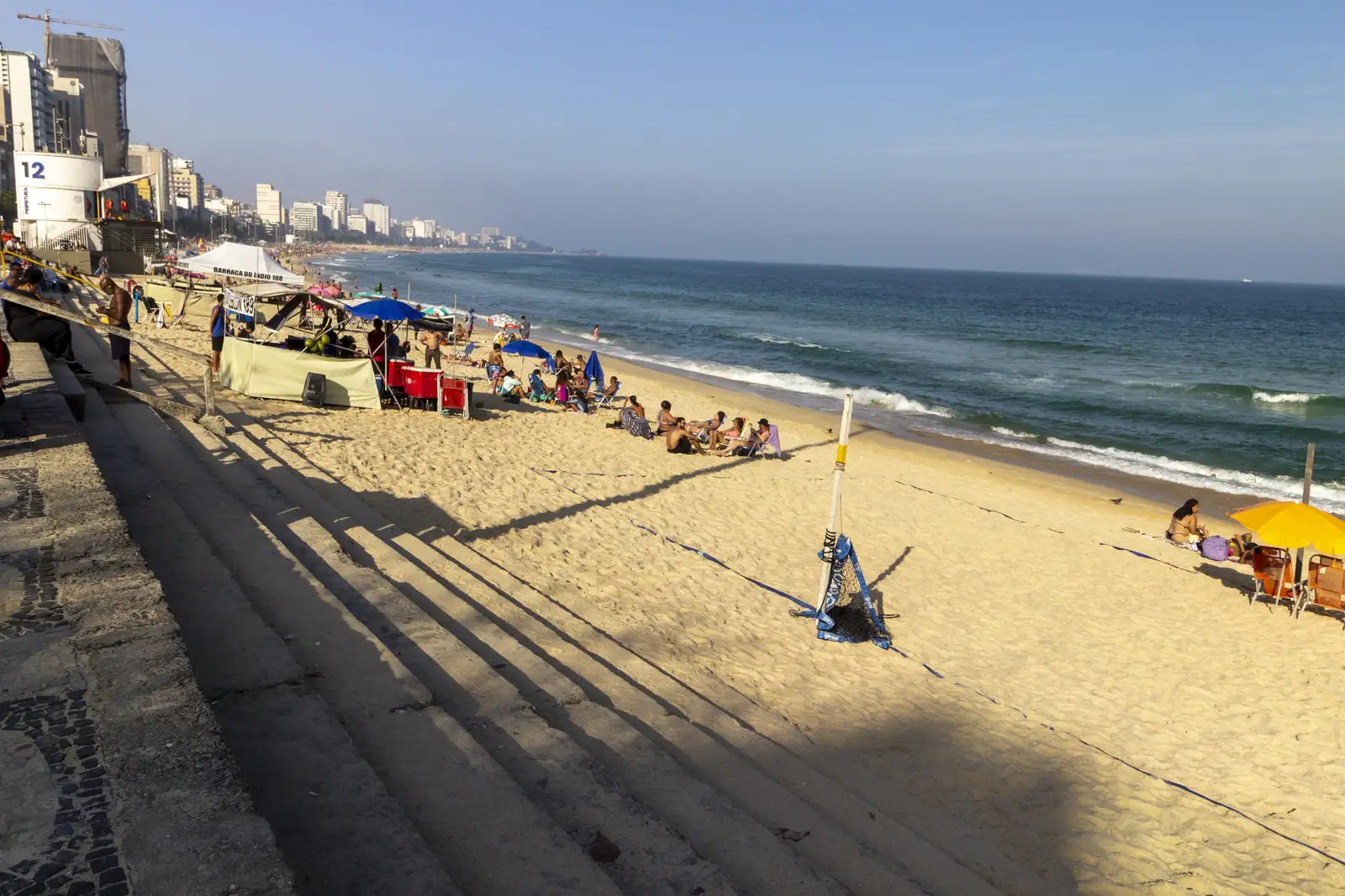 Oceanfront promenade and sandy shore at Praia do Leblon in Rio de Janeiro