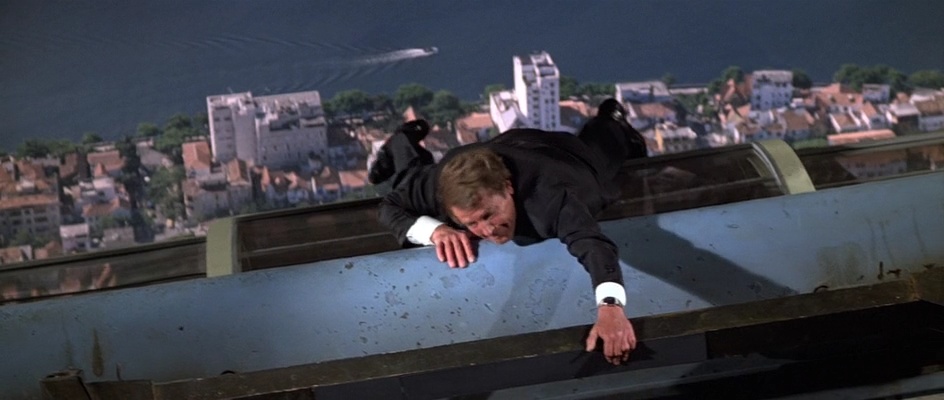 Bond clings to the cable car roof during the attack
