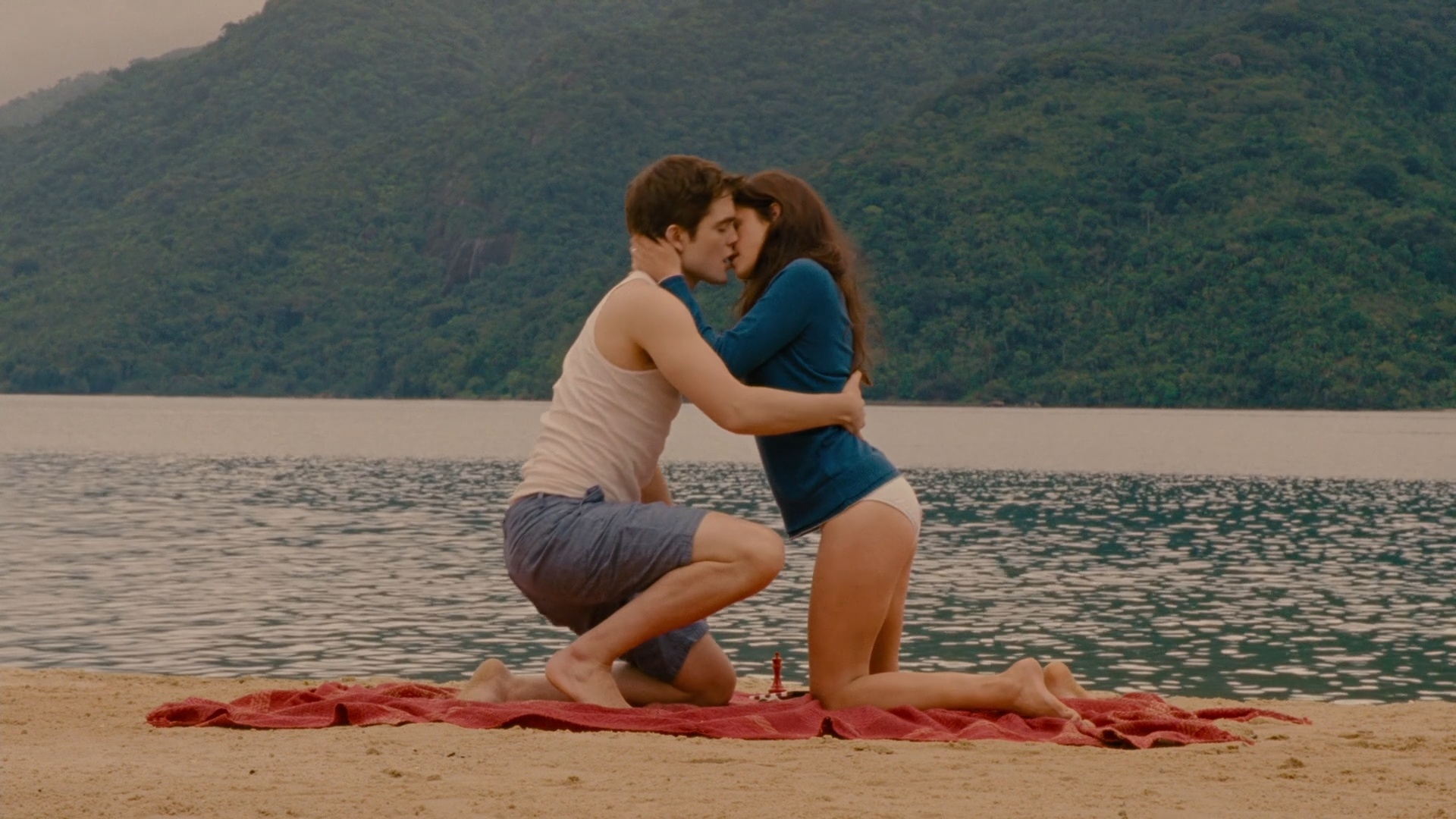 Bella and Edward kiss on the beach during their honeymoon